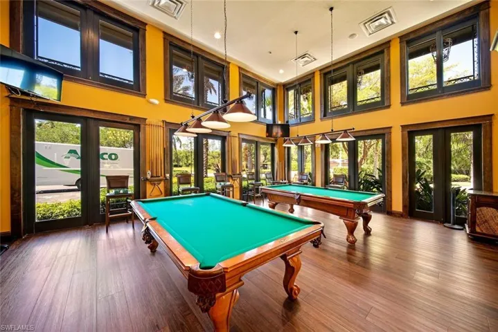 Recreation room with a wealth of natural light, billiards, wood-type flooring, and french doors