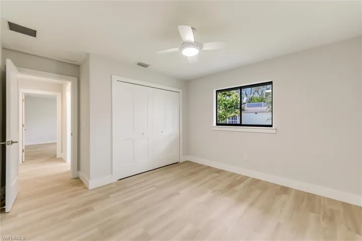 Unfurnished bedroom with a closet, ceiling fan, and light hardwood / wood-style flooring