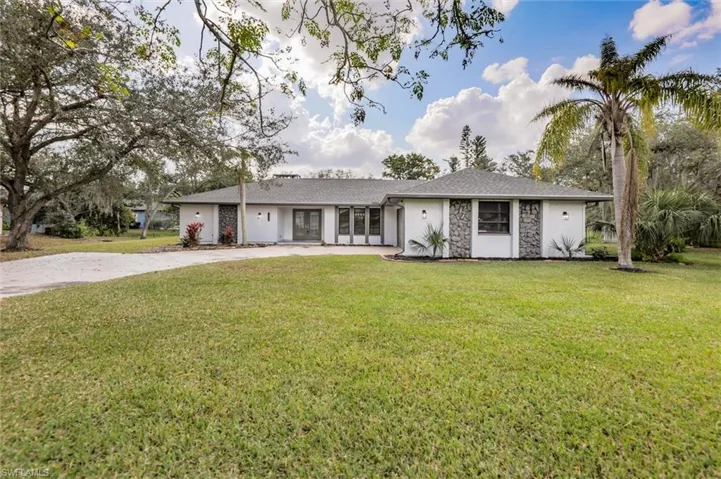 Single story home with a front yard