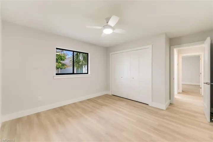 Unfurnished bedroom with light hardwood / wood-style floors, a closet, and ceiling fan