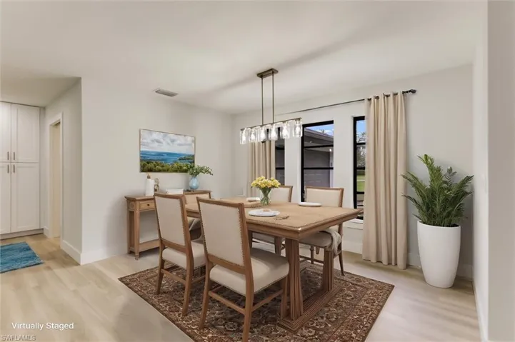 Virtually staged Dining room with light hardwood / wood-style floors