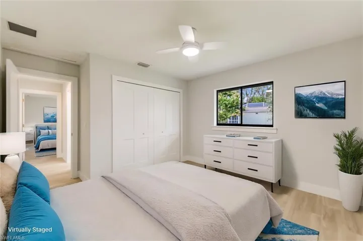 Virtually staged Bedroom featuring a closet, ceiling fan, and light hardwood / wood-style flooring