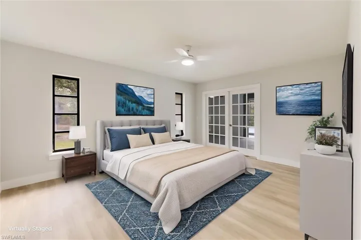 Virtually staged Bedroom featuring hardwood / wood-style flooring, ceiling fan, and french doors