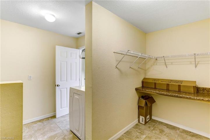 Folding room with 2 counters and plenty of space for hanging clothes.