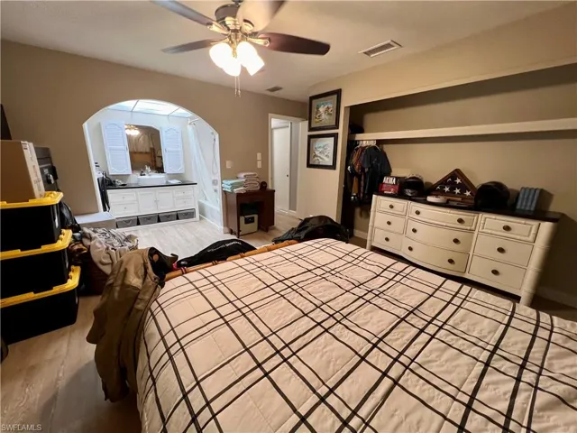 Bedroom with luxury vinyl plank floors, a closet, and ceiling fan