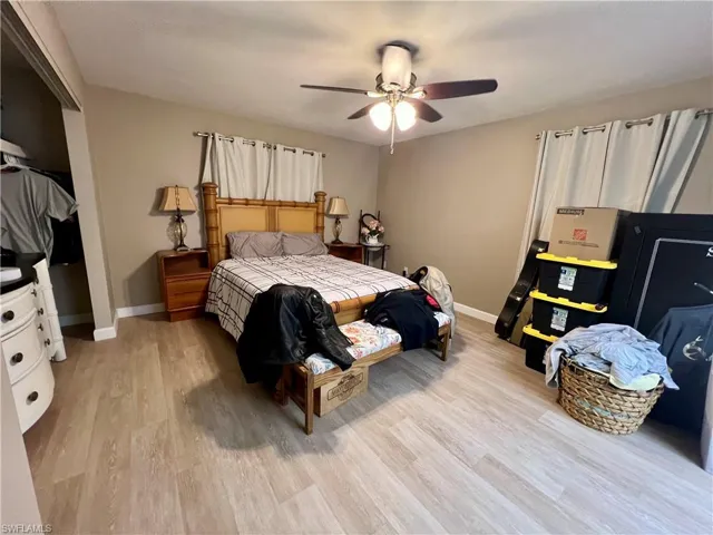 Bedroom with ceiling fan and luxury vinyl plank flooring
