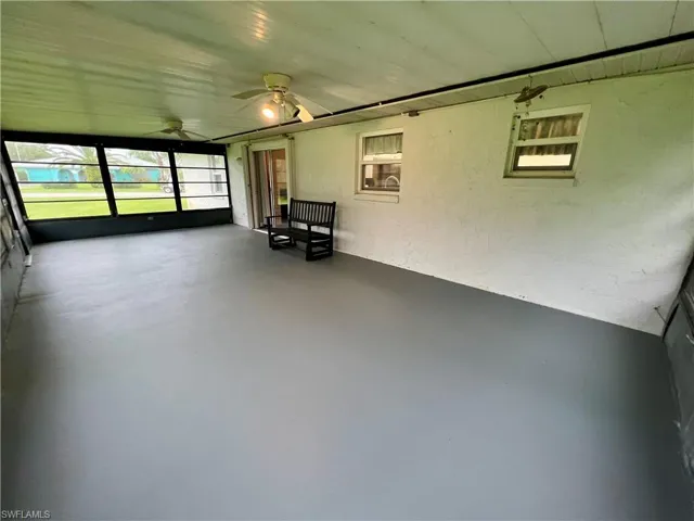 Unfurnished sunroom featuring ceiling fan