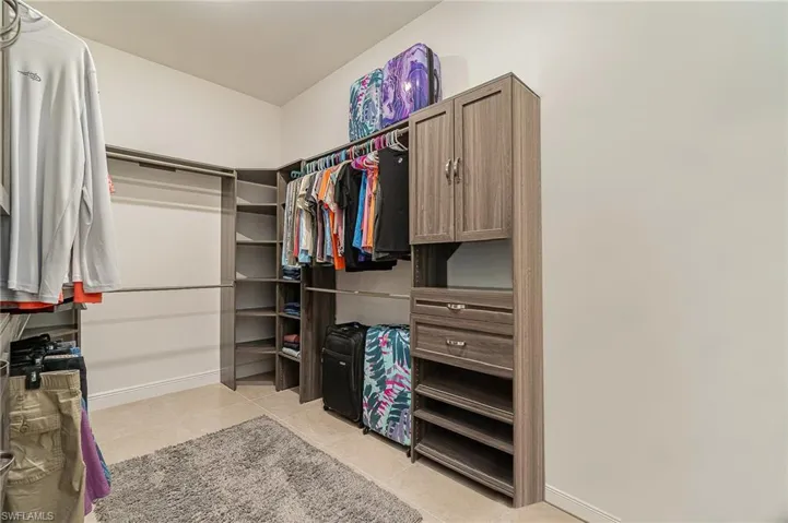 Walk in closet featuring light tile patterned flooring