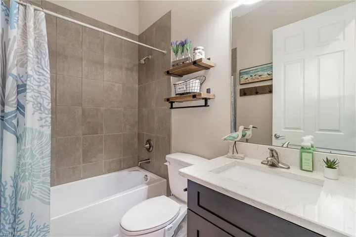 Full bathroom featuring vanity, toilet, and shower / tub combo