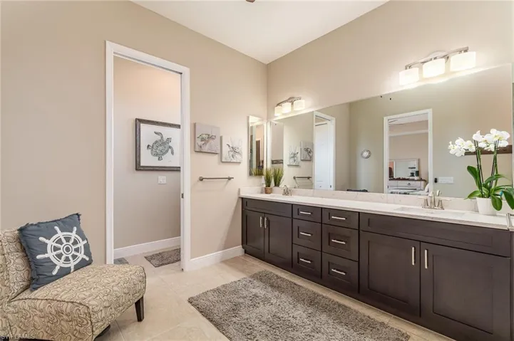 Bathroom with tile patterned floors and vanity