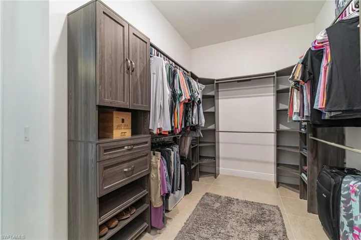 Spacious closet with light tile patterned floors
