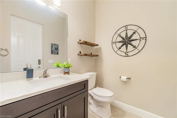 Bathroom with tile patterned flooring, vanity, and toilet