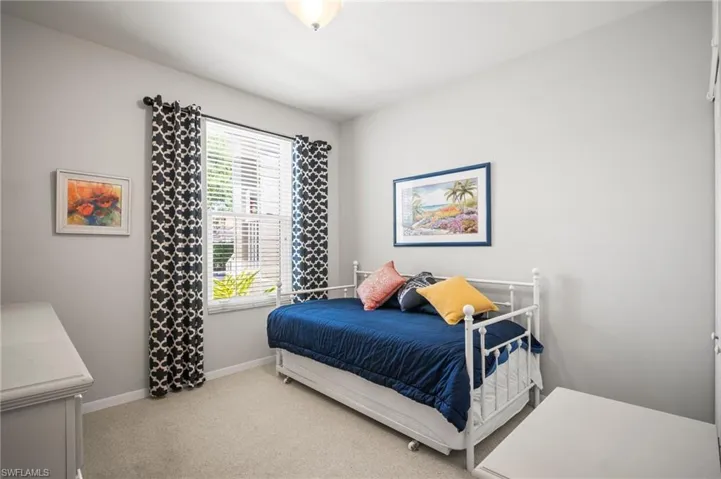 Carpeted bedroom with baseboards