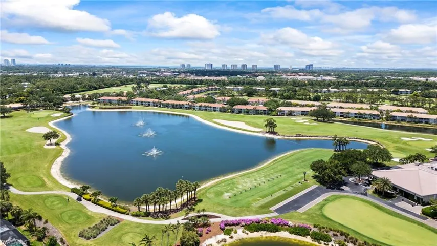 View of urban area with a nearby body of water and a golf club