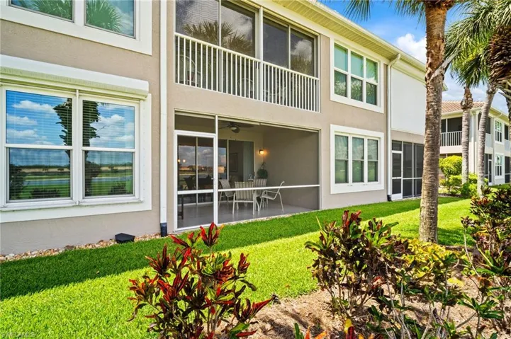 Back of property with stucco siding, a yard, and a patio area