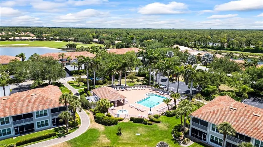 Drone / aerial view of a nearby body of water and a pool