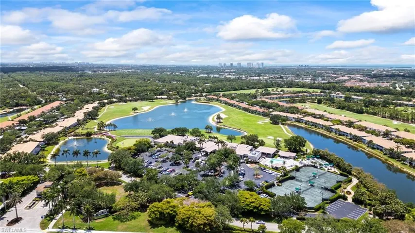 Aerial view of property's location with a large body of water and a golf club