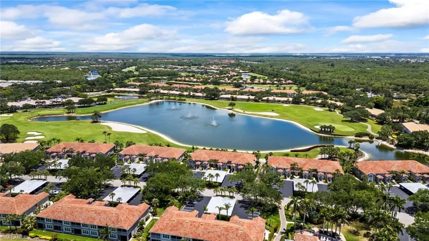 Aerial view of property's location featuring a golf club, nearby suburban area, and a large body of water