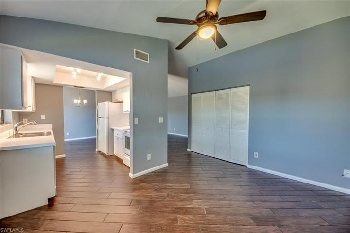 Den/Family Room off Kitchen with Double Window & Views of Lake and Fountain, Wood Look Tile Flooring.