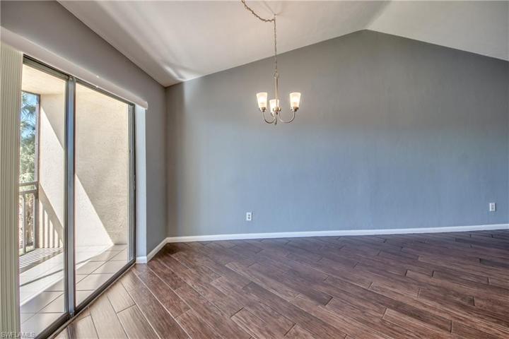Dining area with Sliding Glass Doors leading to Large Lanai and Long Lake and Fountain Views.