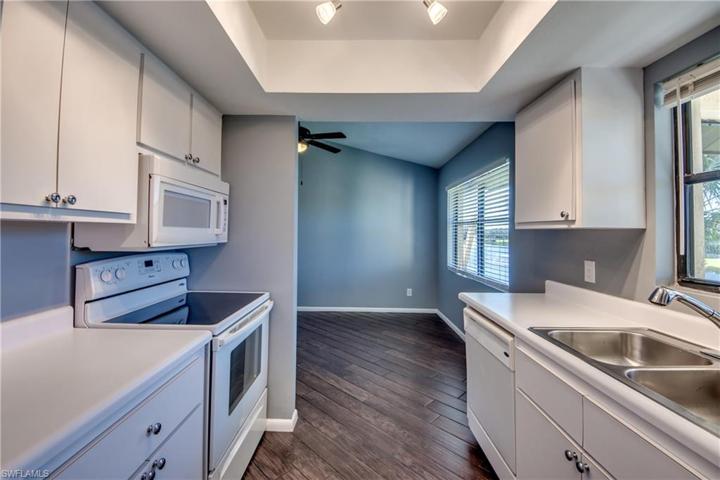 Galley Style Kitchen with coved lighting & a great Lake & Fountain View from the Window! Open to the Dining Area on one end and the Family Room/Den on the other end!
