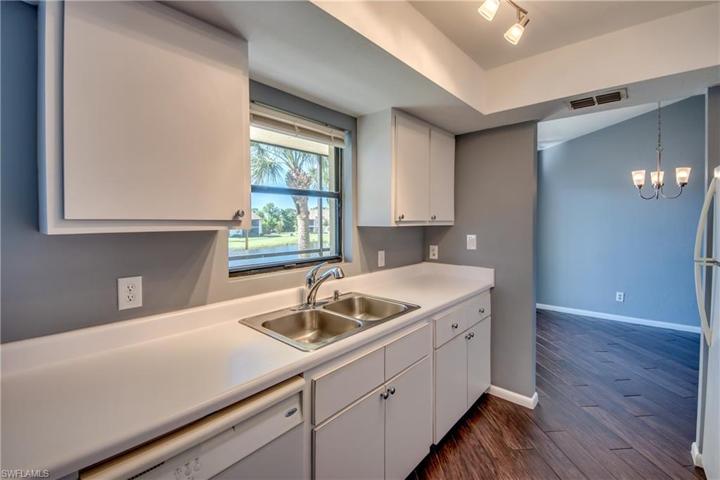 Galley Style Kitchen with coved lighting & a great Lake & Fountain View from the Window! Open to the Dining Area on one end and the Family Room/Den on the other end!