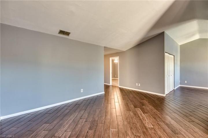 Large Great Room with Vaulted Ceilings & Wood Look Tile Floors