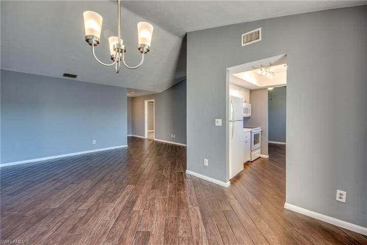 Large Great Room with Vaulted Ceilings & Wood Look Tile Floors