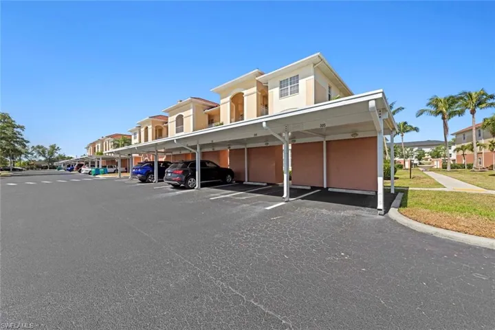 Covered parking lot featuring a residential view
