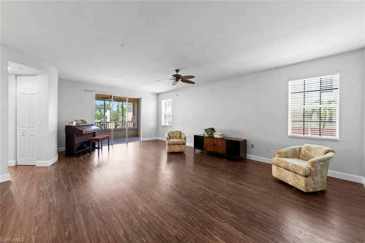 Living area featuring baseboards, ceiling fan, and wood finished floors