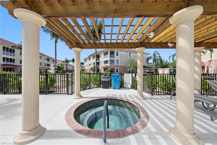 View of pool with a residential view, a pergola, and a hot tub
