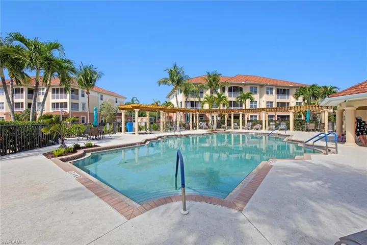Pool with a patio and fence