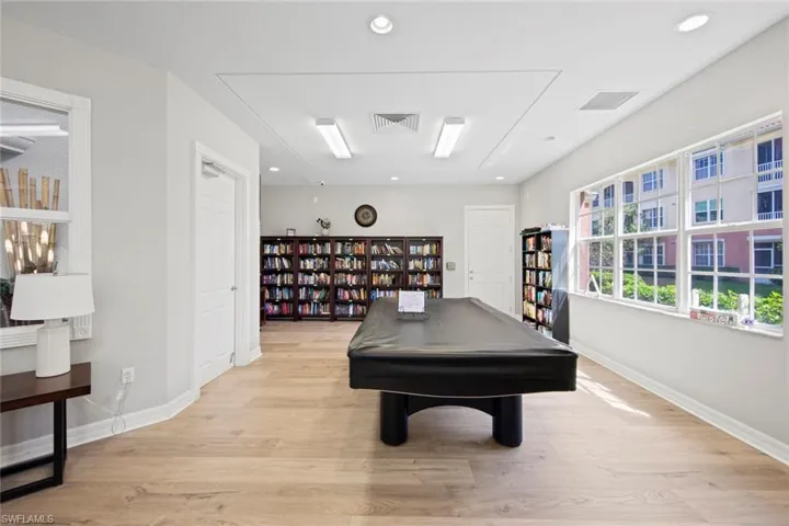 Recreation room featuring light wood finished floors, visible vents, baseboards, and recessed lighting