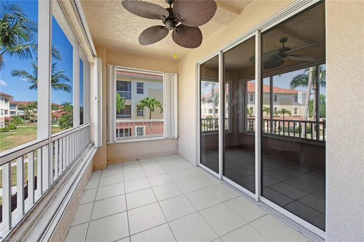 Unfurnished sunroom with a ceiling fan
