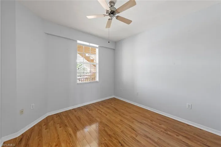 featuring light wood-type flooring, baseboards, and a ceiling fan