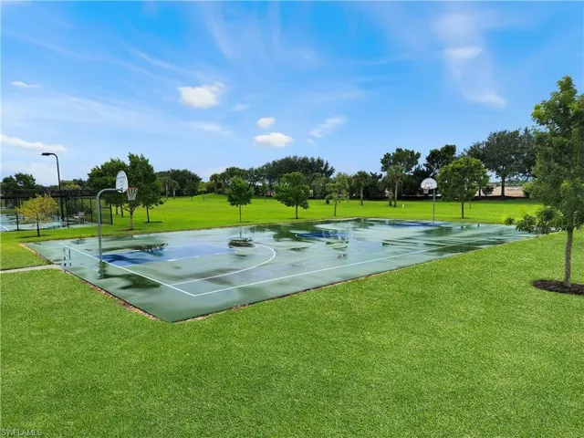 View of basketball court with a lawn