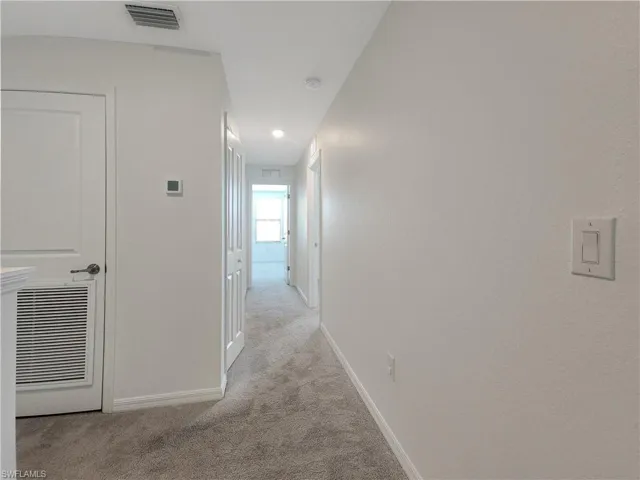 Hallway with light carpet