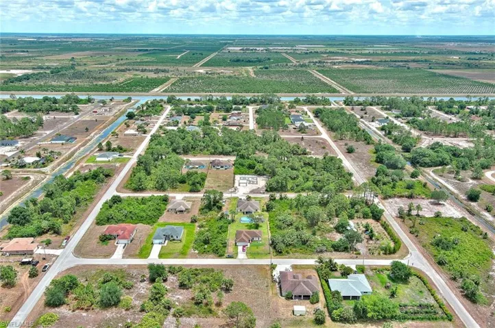 Aerial view of property and surrounding area featuring large plots for crops and rural landscape
