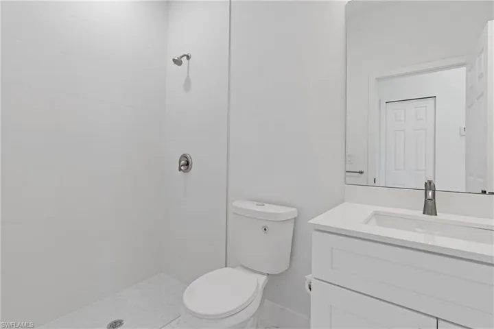 Full bathroom with vanity and tiled shower