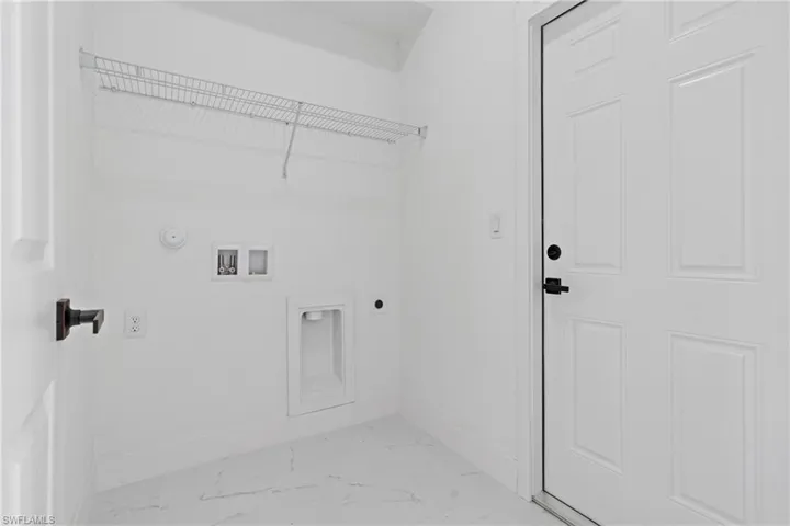 Washroom with hookup for an electric dryer, light marble finish floors, washer hookup, and gas dryer hookup