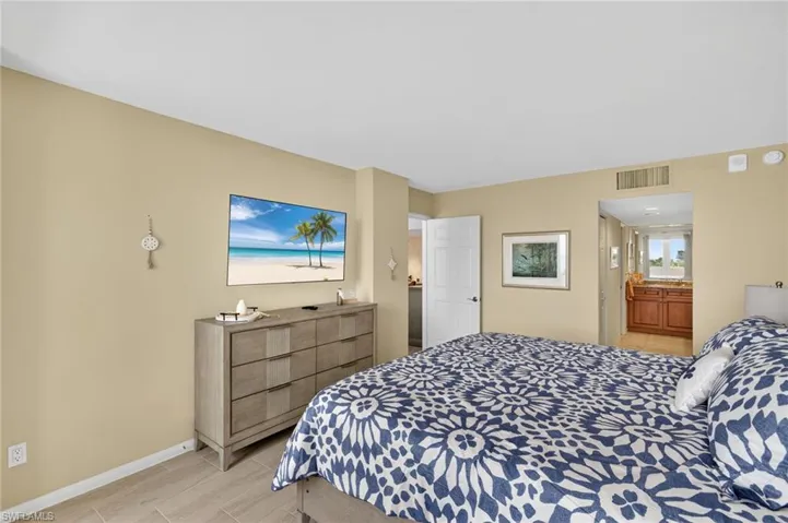 Bedroom with baseboards and ensuite bath