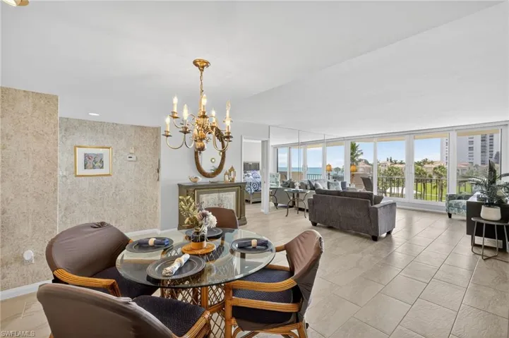 Dining area with a chandelier and floor to ceiling windows