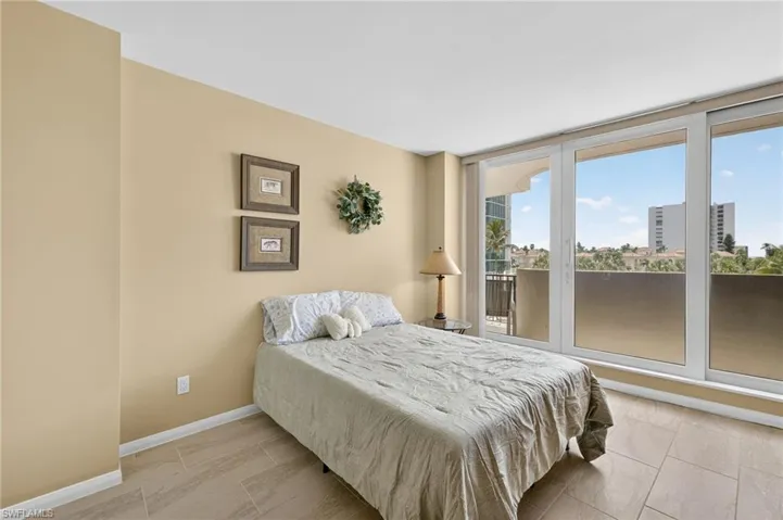 Bedroom with access to exterior and baseboards