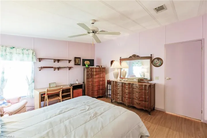 Bedroom with ceiling fan and hardwood / wood-style floors