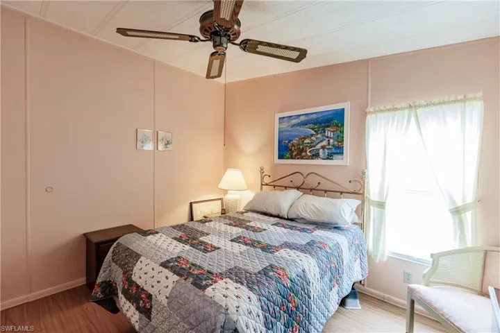 Bedroom featuring ceiling fan and hardwood / wood-style flooring
