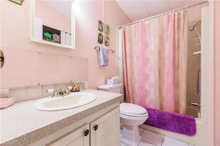 Bathroom featuring tile patterned floors, toilet, and vanity