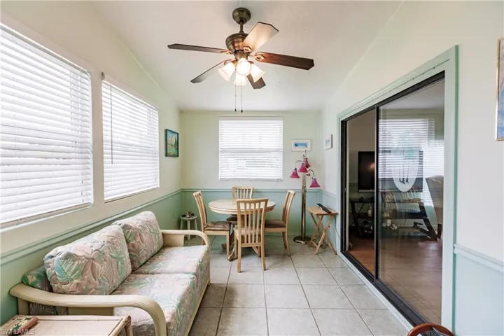 Dining space featuring ceiling fan, lofted ceiling, and light tile patterned floors
