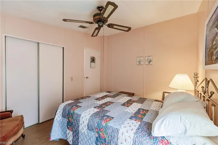 Bedroom featuring ceiling fan and wood-type flooring