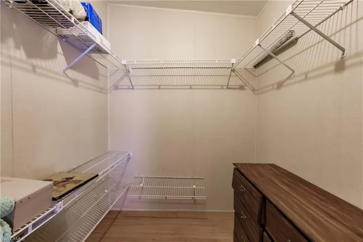 Walk in closet featuring hardwood / wood-style flooring