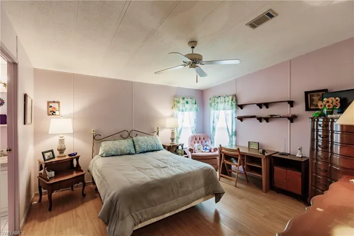 Bedroom featuring a textured ceiling, ceiling fan, and light wood-type flooring